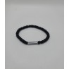 Bracelet noir spiralé avec anneau métal argenté. Bijou moderne, minimaliste et masculin en acier inoxydable.